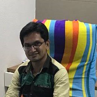 Alpesh Mundadiya, ASP.NET developer, at his desk in Rajkot